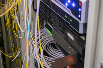 There is a rack with multimedia server equipment in the data center. Hosting platform of the Internet provider. Many wires are connected to the interfaces of the server equipment