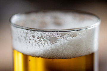 Beer glass details with fresh bubbles and foam. Iced beer details on glass