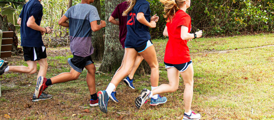Boys and girls running in a park together