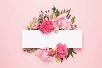 Beautiful composition with hortensia flowers and blank card on pink background, top view. Space for text