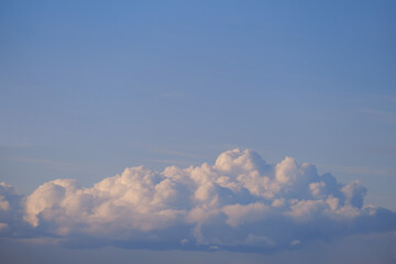 Large white cloud against a blue sky, copy space