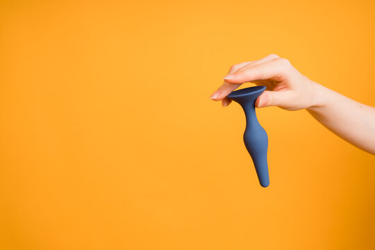 Adult sex toys, blue butt plug on an orange background