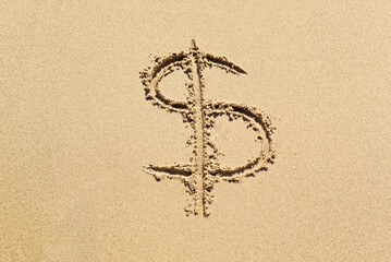 Dollar sign in the sand. Expensive vacation concept.