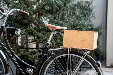 Vintage bicycle with a wooden box on the trunk is parked in a bicycle parking lot (1003)
