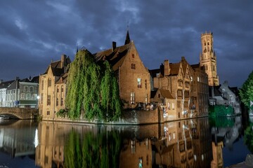 Fototapeta na wymiar Bruges, Belgium. September 30, 2019: Muelle del Rosario at night and reflection in the water of the canal.