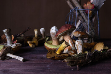 Forest mushrooms lie on a wooden table