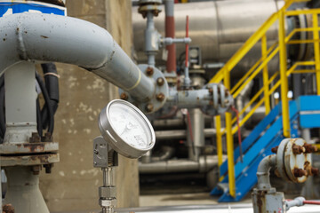 Fototapeta na wymiar Industrial pressure gauge on the background of a chemical plant. Pressure gauge readings.