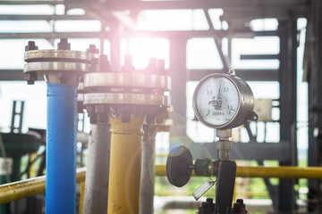 Industrial pressure gauge on the background of a chemical plant. Pressure gauge readings.