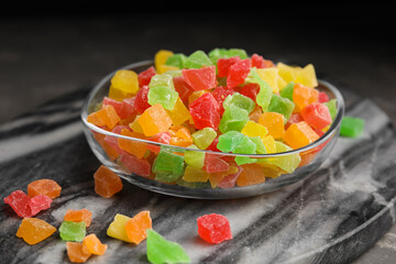 Mix of delicious candied fruits on marble board, closeup