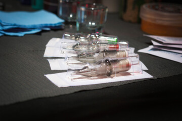 Latin person tattooing arm, with adequate security measures in his workplace happy and calm comfortable in his chair