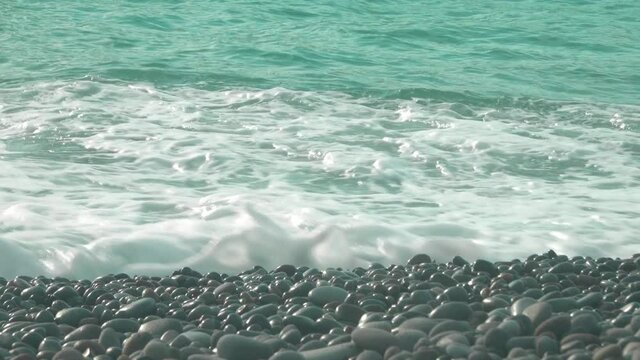 Waves breaking onto a pebble beach in real time. Filmed at Looc beach in the Philippines.