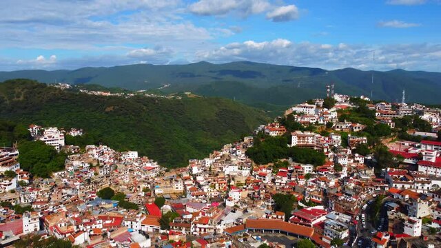 Rolling hills and terraced Spanish colonial homes make up the landscape of Taxco Mexico.
