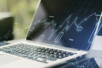 Multi exposure of abstract financial graph on laptop background, financial and trading concept