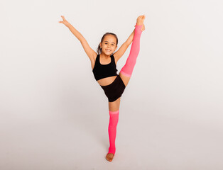 little girl gymnast on a white background. sport exercises. stretching. flexibility. aerobics