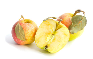 two apples with leaves and a half of apple with green leaf isolated on white background