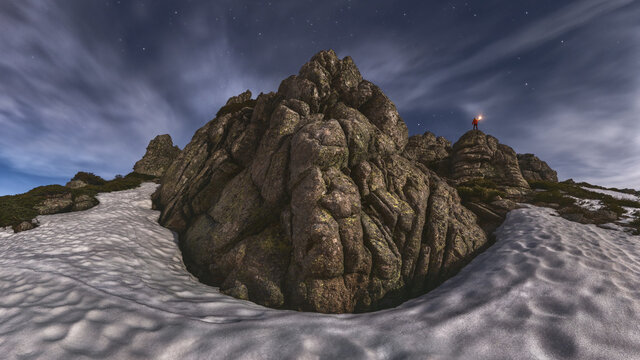 Traveler on mountain among sandy land in twilight