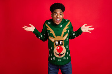 Portrait of attractive curious cheerful guy shrugging shoulders newyear party isolated over bright...