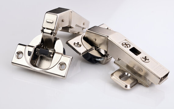 Belarus, Minsk - 12.09.2021:BLUM kitchen door hinge on a white background. Blum fittings. Blum GmbH is an international company that produces hinge, lift and slide systems for furniture. 