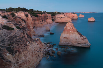 Sunny day in the Beach at Algarve, Portugal with turquoise sea in background. Bird eye view of the cliffs of Algarve. Aerial view. Concept for travel in Portugal and most beautiful places in Portugal.