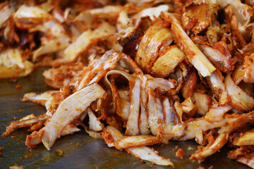 selective focus, breaded chicken doner, kebab sandwich on table. swirls between chubby bread