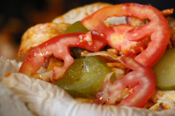selective focus, breaded chicken doner, kebab sandwich on table. swirls between chubby bread