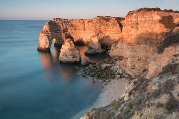 Fototapeta na wymiar Sunny day in the Beach at Algarve, Portugal with turquoise sea in background. Bird eye view of the cliffs of Algarve. Aerial view. Concept for travel in Portugal and most beautiful places in Portugal.
