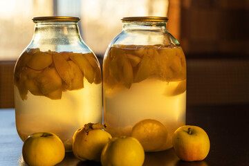 apple compote in glass jars on the kitchen table, soft evening light