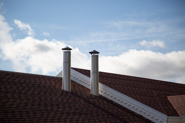 Stainless steel pipes. Pipes in the house.The chimney in the house. - obrazy, fototapety, plakaty