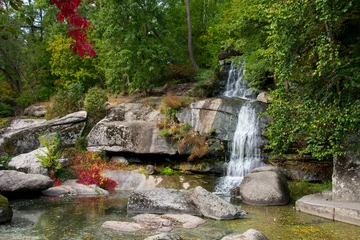 Poster de jardin Paysages stone mountain waterfall and lake. A picturesque cascade waterfall among large stones in the Landscape Park, in spring or summer. big waterfalls, nature. Europe, Ukraine, Uman, Sofiyivka arboretum  © Oleksandr Filatov