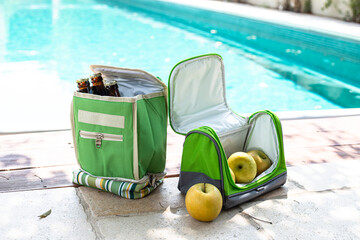Carrying portable bags refrigerators for food and drinks. Poolside picnic