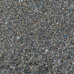 sea beach of small multi-colored pebbles as a natural background