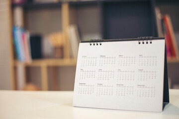 Calendar desk place on table. Desktop Calender for Planner to plan agenda, timetable, appointment, organization, management each date, month, and year on wooden office table.Calendar Concept.