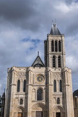 Fototapeta na wymiar Facade of Basilica of Saint-Denis (Basilique royale de Saint-Denis, from 1144) - former medieval abbey church in city of Saint-Denis, a northern suburb of Paris. France.