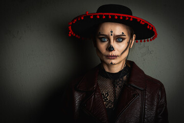 close up portrait of Calavera Katrina. Sugar skull makeup in a hat on a gray background. Dia-de -los -muertos. Day of the Dead. Halloween