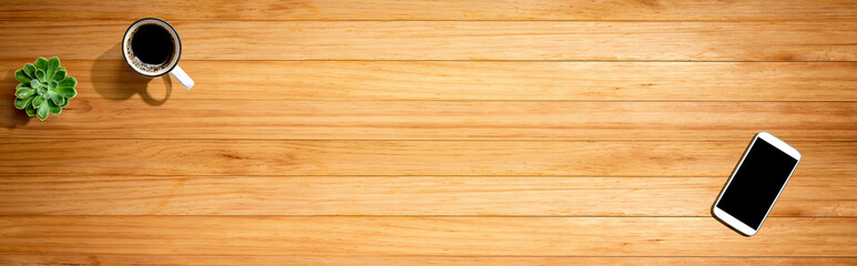 Smartphone with a coffee mug and succulent plant - flat lay