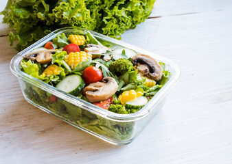 Lunch box with green salad and vegetables for lunch during work breaks, school