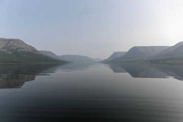 Fototapeta na wymiar Putorana Plateau, a misty haze over the lake.