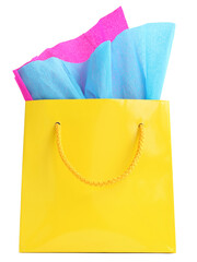 Yellow gift bag stuffed with pink and turquoise tissue paper, isolated on white
