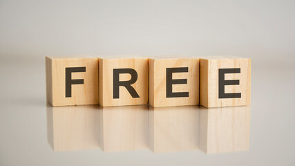 Four wooden cubes with letters Free. Business marketing concept
