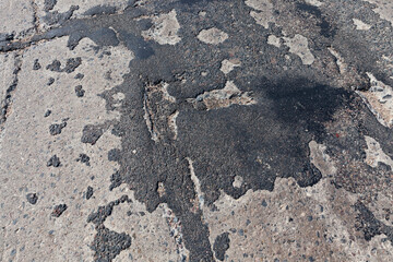 a bad road with poorly repaired potholes and pits