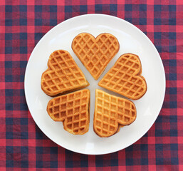 heart-shaped waffles on a plate top view