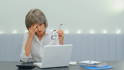 A tense middle-aged elderly business lady, very upset about a big problem or a mistake that she...