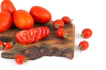 organic red tomatoes on wooden background on white background