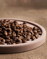 Coffee beans close-up. Macro photography of coffee on a brown background. A place for text in food photos. Arabica.