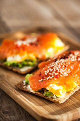 Salted salmon, scrambled eggs, avocado and cream cheese rye crisp toast