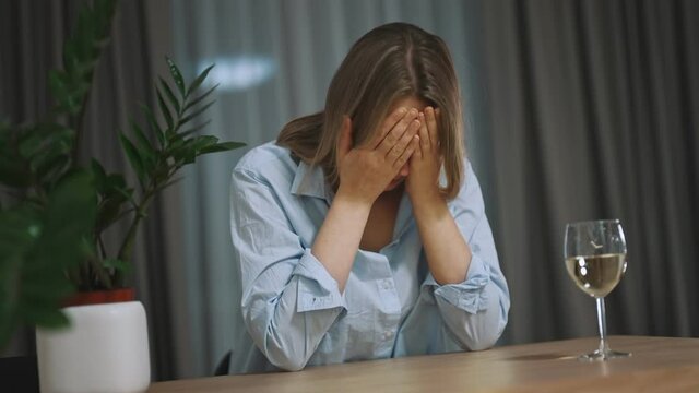 Woman suffering from depression and drinking alcohol.