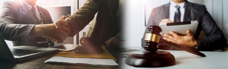 Justice and law concept.Male judge in a courtroom with the gavel, working with, computer and docking keyboard, eyeglasses, on table in morning light