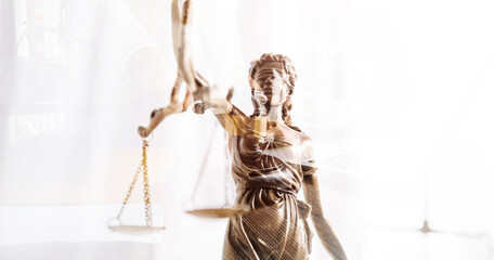 Justice and law concept.Male judge in a courtroom with the gavel, working with, computer and docking keyboard, eyeglasses, on table in morning light