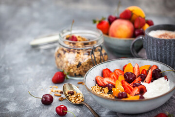 Healthy breakfast with granola, yogurt, fresh berries and coffee