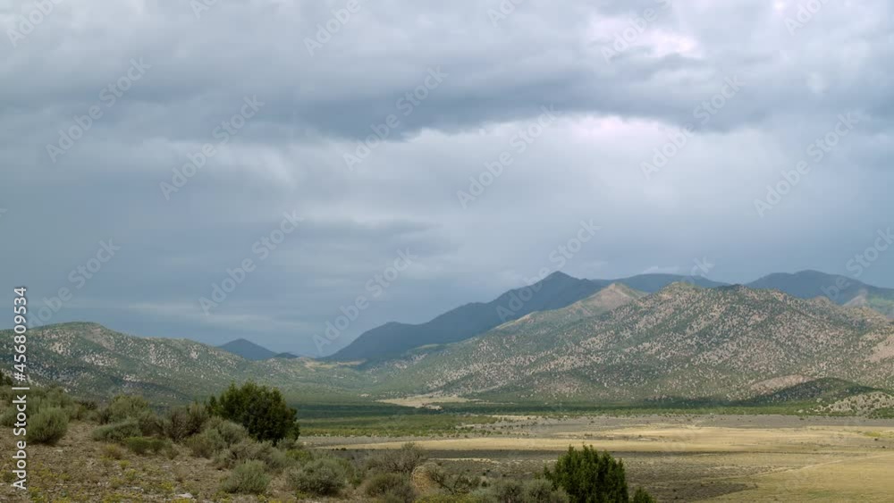 Wall mural time-lapse looking up towards flat top mountain in utah as clouds move through the sky.